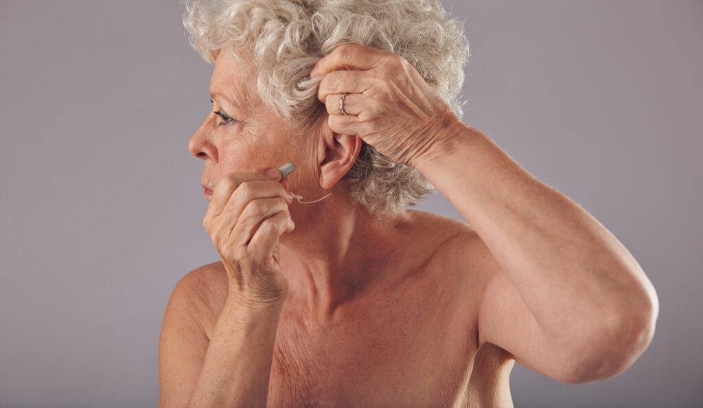 Senior woman wearing a hearing aid